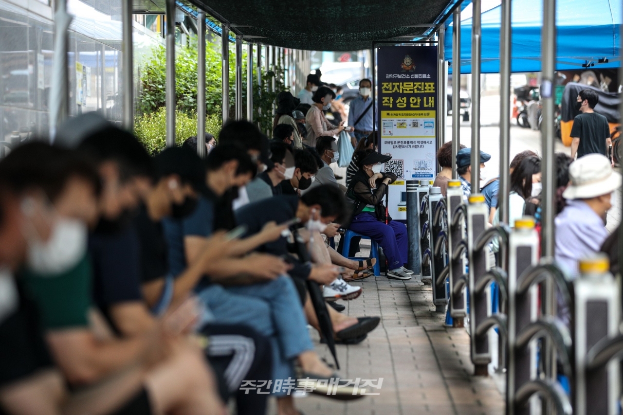 0시 기준 국내 코로나19 신규확진자가 1,418명으로 집계된 23일 오전 서울 관악구보건소에 설치된 코로나19 선별진료소를 찾은 시민들이 검사를 받기 위해 대기하고 있다.